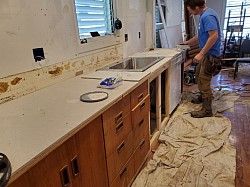 Installing used cabinets and repairing dry wall with ceramic tile